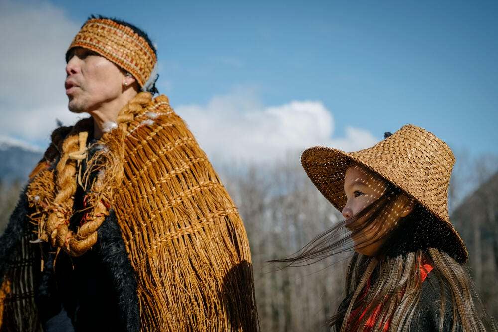 Nuxalk dancer Lyle Mack and his daughter during the drumming at the eulachon ceremony on the banks of the Bella Coola River, in the town of Bella Coola,  on the central coast of British Columbia.