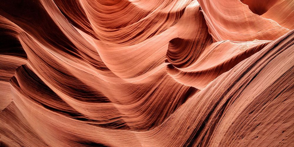 Abstract view of the red flowing rocks of a slot canyon.