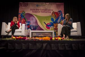 Jen Morris and Katharine Hayhoe on stage having a discussion.